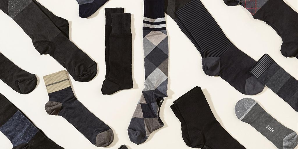 Different styles of men’s black socks arranged neatly.