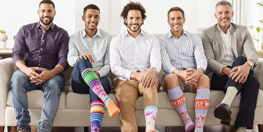 Men wearing colorful compression socks in a cozy setting