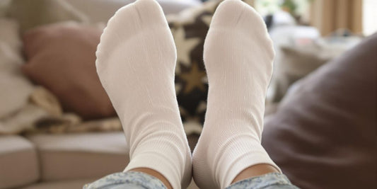 Person wearing soft diabetic socks relaxing on a couch