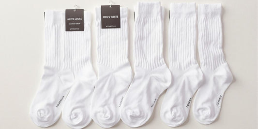 Assorted white men's socks in different styles and lengths.