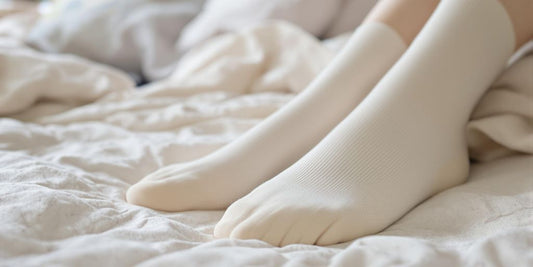 Soft diabetic socks on a cozy bed in natural light.