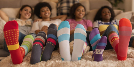People relaxing at home wearing colorful compression socks