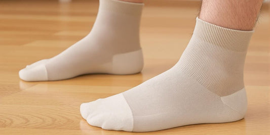 Man's feet in soft crew diabetic socks on floor