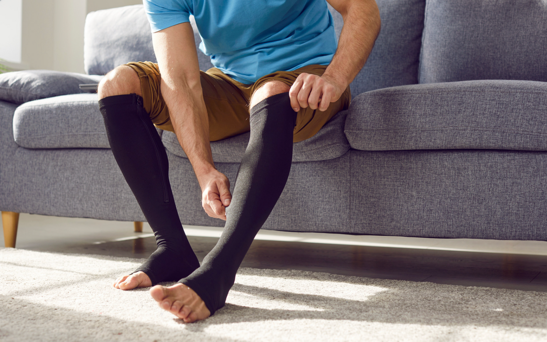 Person wearing compression socks on swollen diabetic feet.