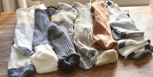 Variety of extra wide men's socks on wooden surface