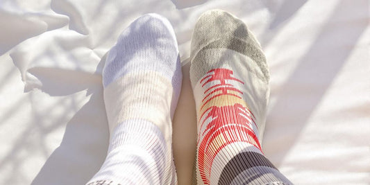 Close-up detailed view of thin and thick socks on foot.