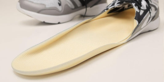 Foam insoles partially removed from athletic shoes