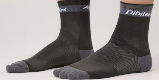 Comfortable diabetic dress socks on feet, neutral background.