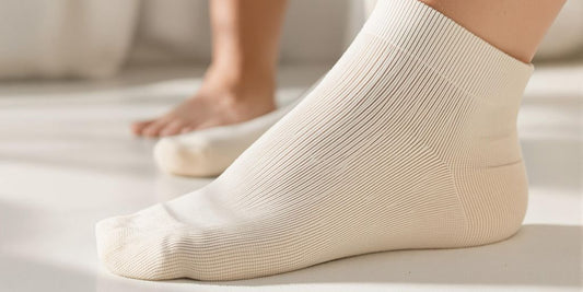 Soft diabetic socks and healthy feet on clean surface.