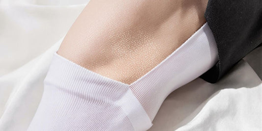 Close-up clear view of dress socks on leg, showing indentations.