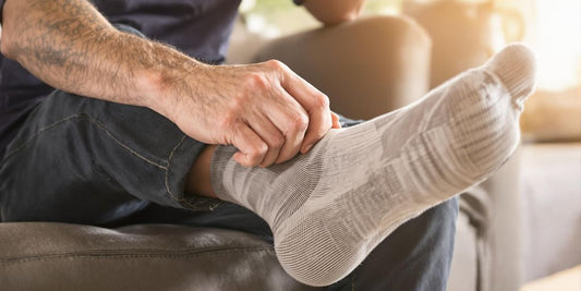 Man putting on cushioned neuropathy socks for comfort