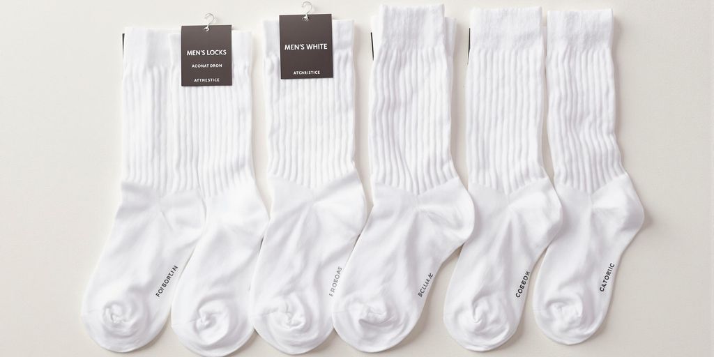 Assorted white men's socks in different styles and lengths.