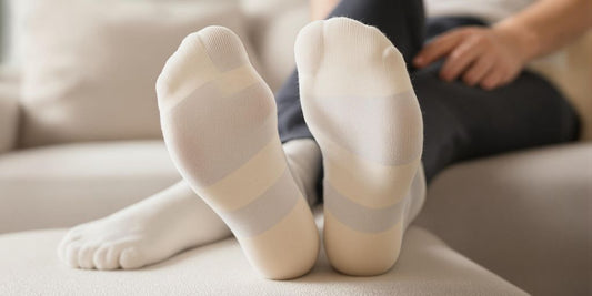 Person wearing soft, non binding socks on a couch