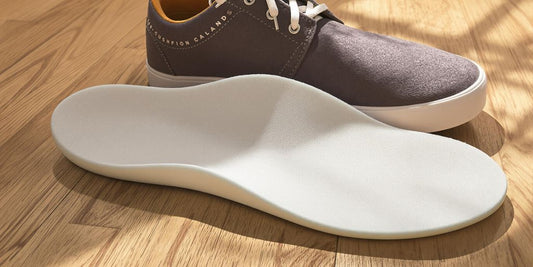 Soft cushion insoles inside sneakers on wooden floor