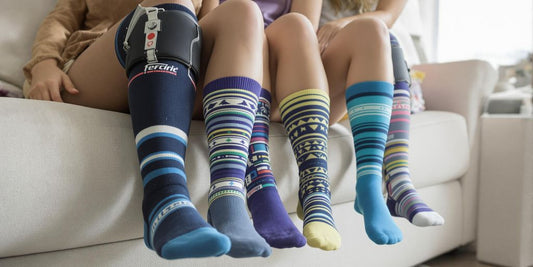 People wearing colorful medical compression socks indoors