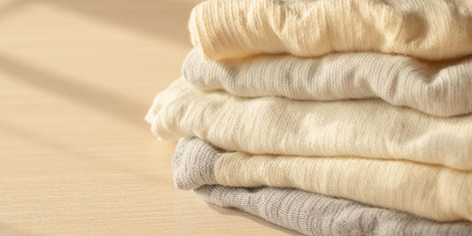 Soft socks resting on wood bathed in warm natural light.